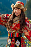 Woman in  red silk Tibetan Clothing with gold patterns